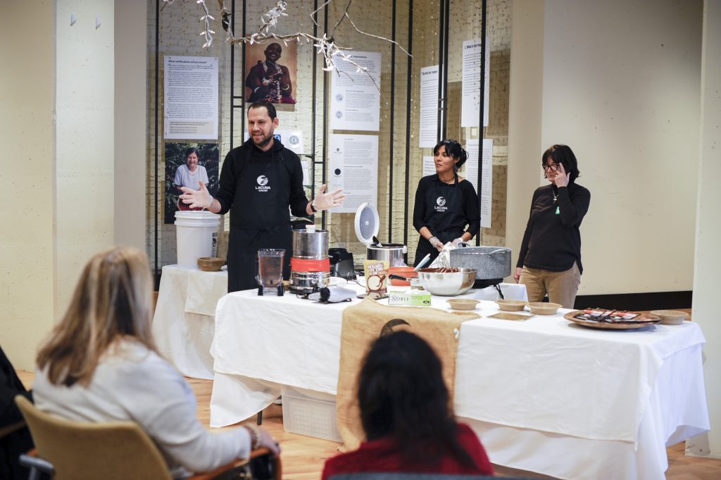 Three people giving a presentation on cacao