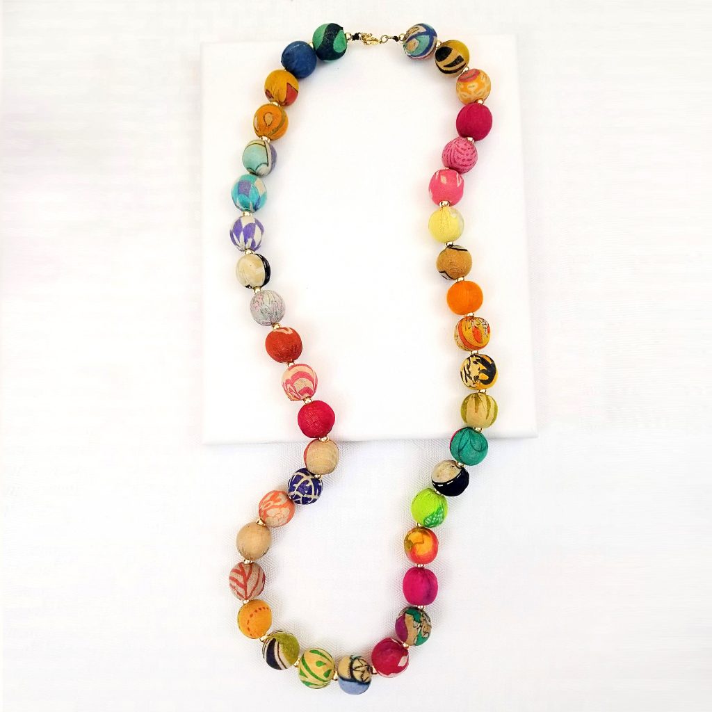 Colorful beads made from recycled Kantha textiles are dotted with brass beads and strung together for a classic look.