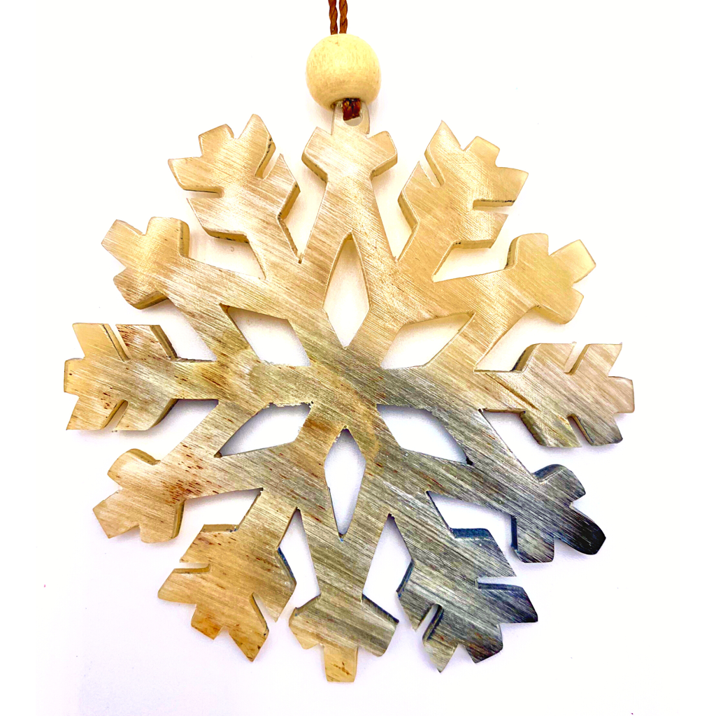 Snowflake eco-friendly handmade ornament made from natural discarded and recycled bull horn crafted by Peruvian artisans.